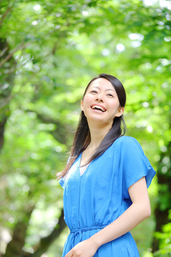 Asian woman outdoors smiling